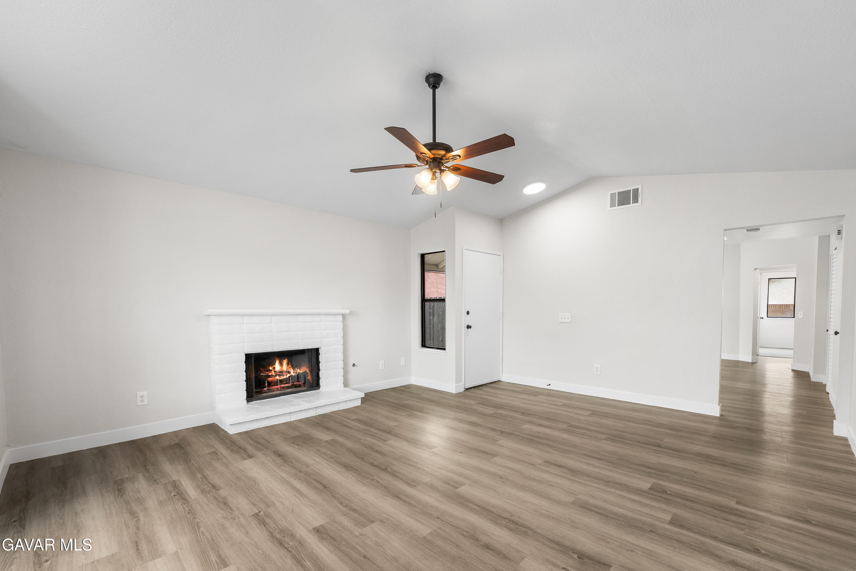 3563 Avenue R11 E Palmdale Ca East Palmdale, CA 93550 - Photo 9 of 37 a view of a livingroom with a ceiling fan and wooden floor