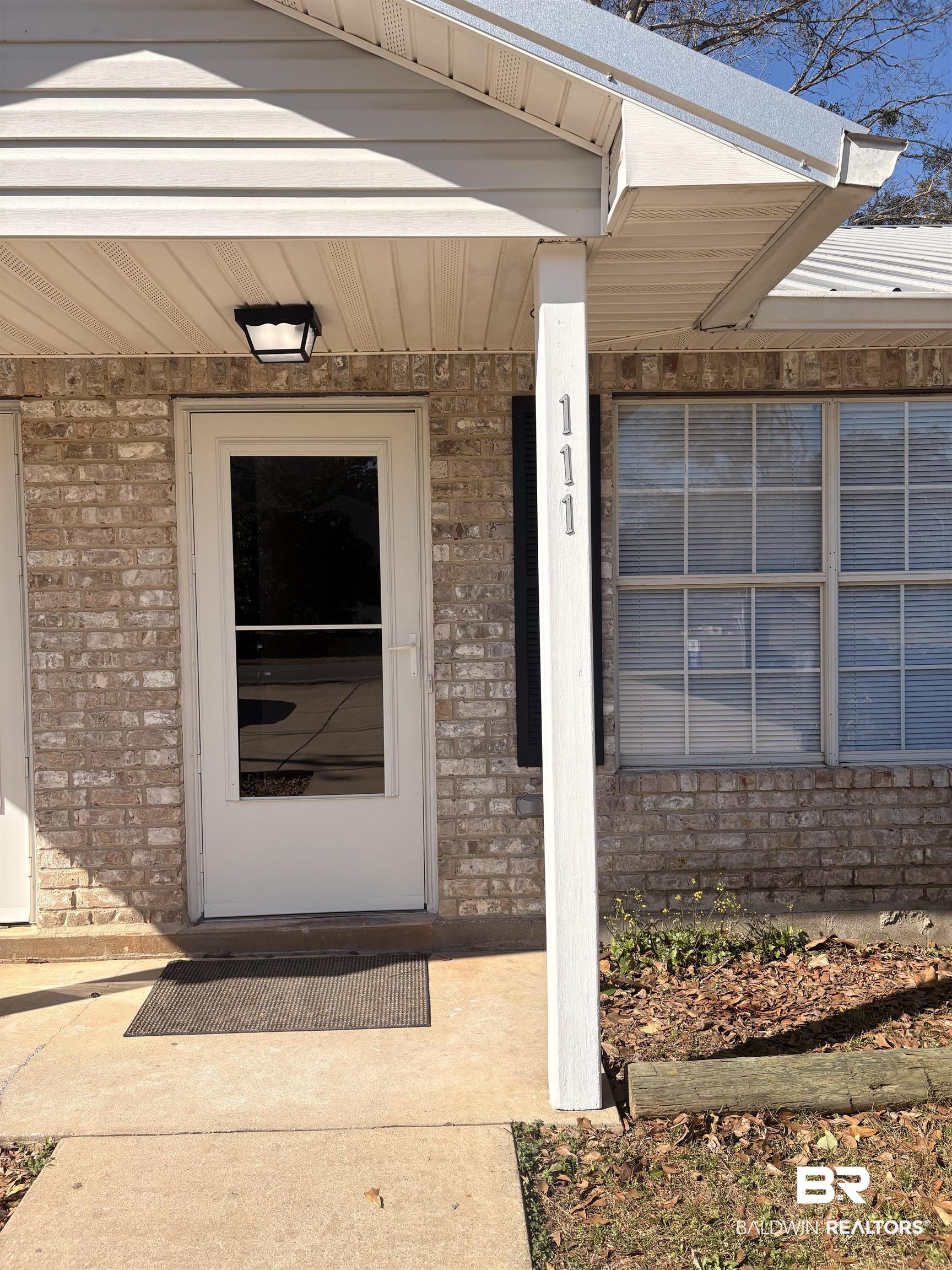109-111 North Beech Street, Unit A & B Foley, AL 36535 - Photo 10 of 16 Entrance to property with brick siding and a porch