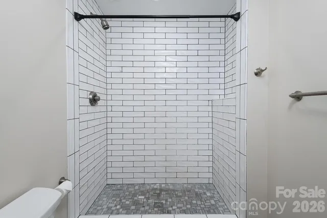 a bathroom with a toilet and a shower