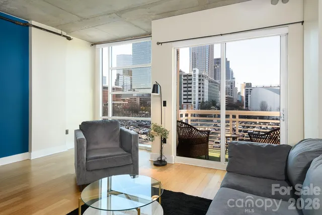 a living room with furniture and kitchen view