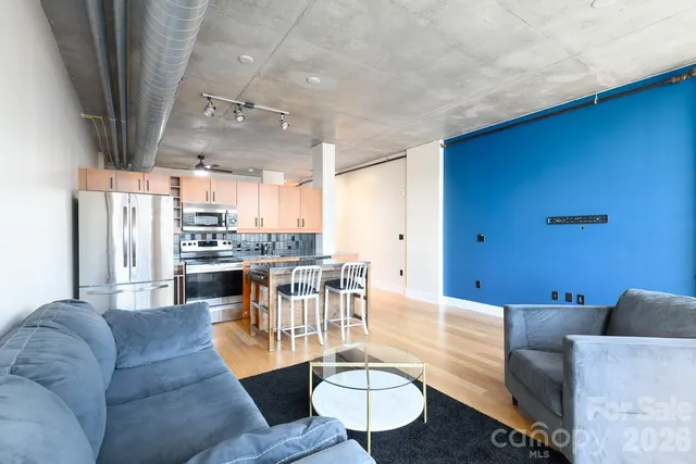 a kitchen with stainless steel appliances granite countertop a refrigerator and a stove