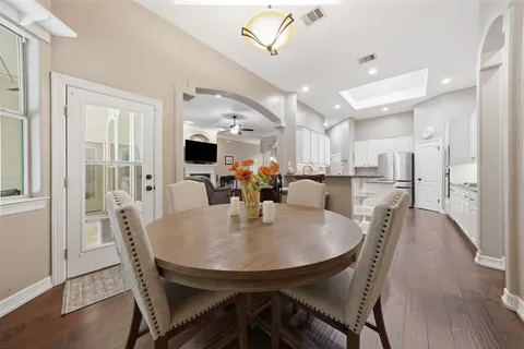 a kitchen with kitchen island stainless steel appliances a sink stove and refrigerator
