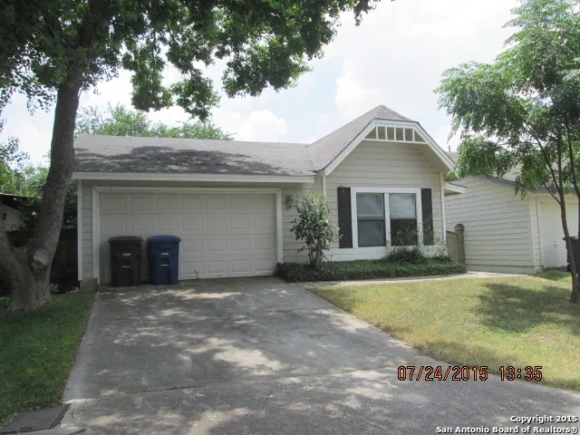 a front view of a house with a garden and yard