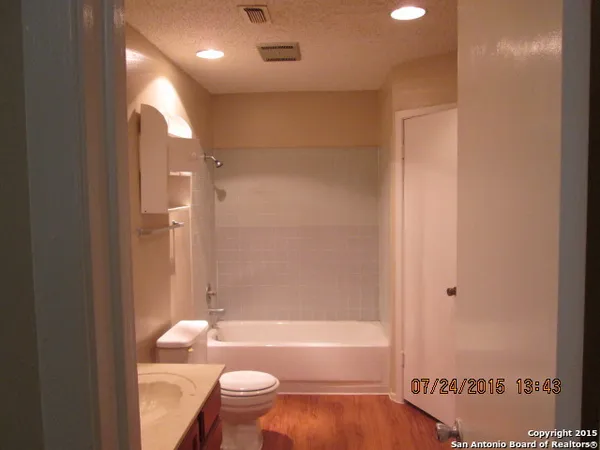 a bathroom with a bathtub and a toilet