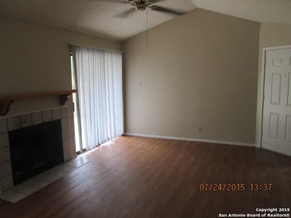wooden floor in an empty room with a fireplace