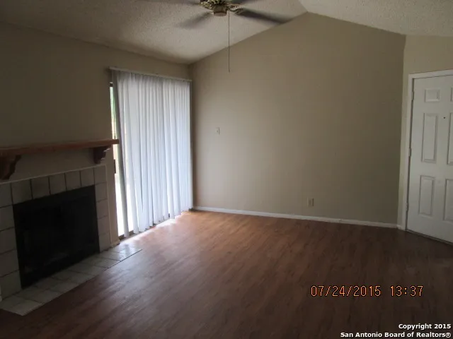 wooden floor in an empty room with a fireplace