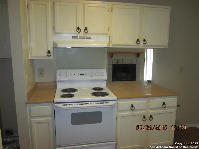 a stove top oven sitting inside of a kitchen