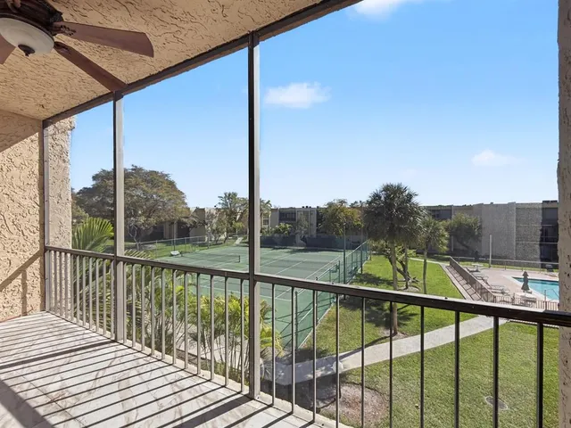 a view of a balcony with yard