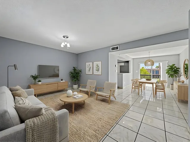 a living room with furniture and a dining table with garden view