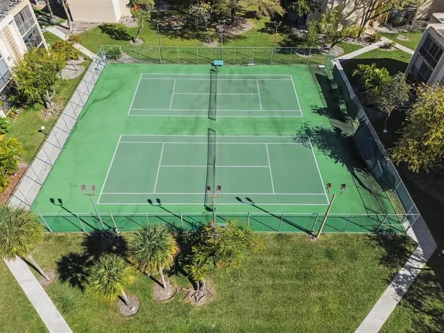 a green field with lots of trees