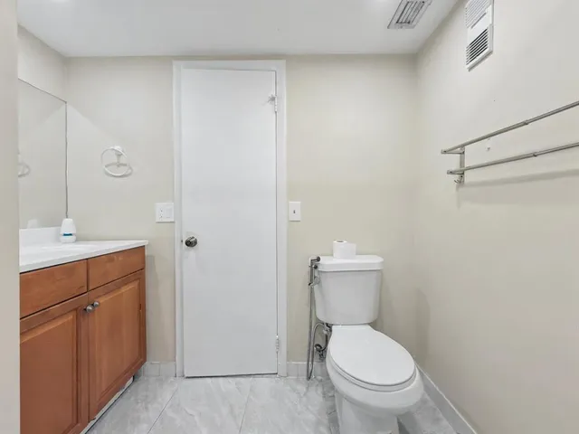 a white toilet sitting next to a bathroom sink