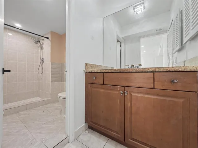 a bathroom with a shower a sink and a mirror