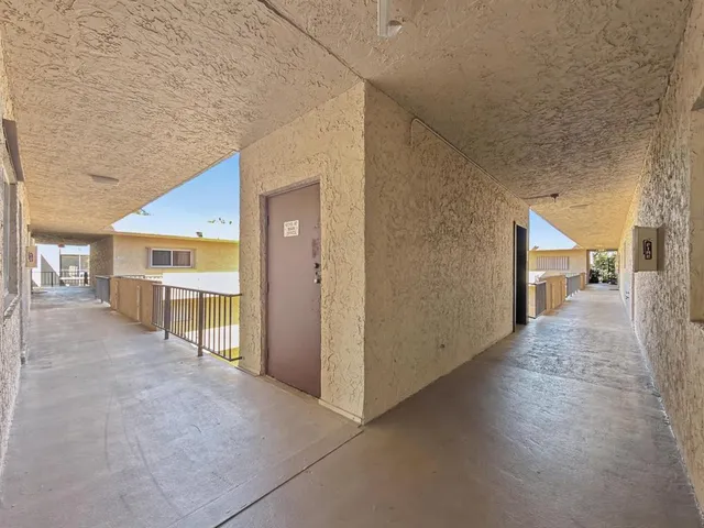 a view of a hallway with seating space