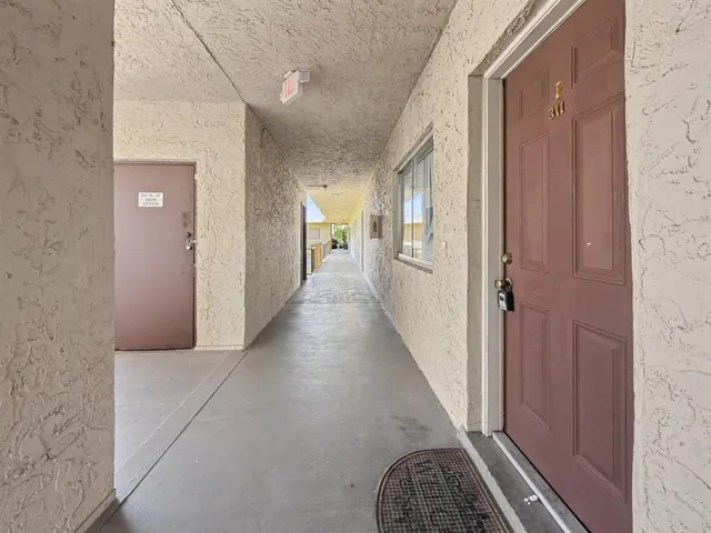 a view of hallway with wooden floor