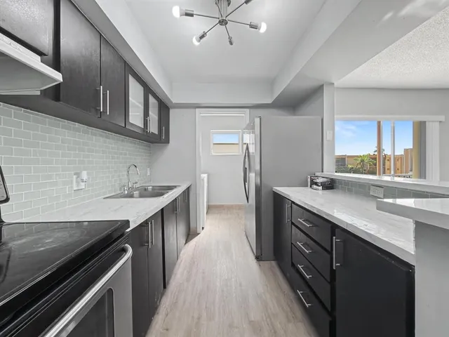 a kitchen with a sink stove and cabinets