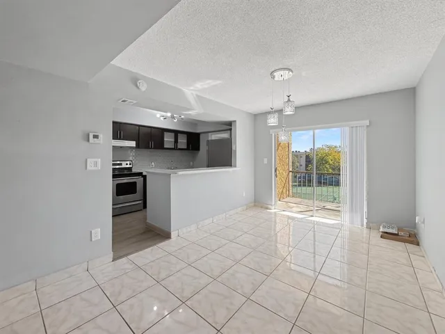a open kitchen with cabinets and stainless steel appliances