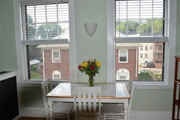 110 Lanark Road, Unit 5 Boston, MA 02135 - Photo 4 of 17 a view of a dining room with furniture window and outside view