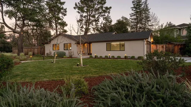 a front view of a house with garden