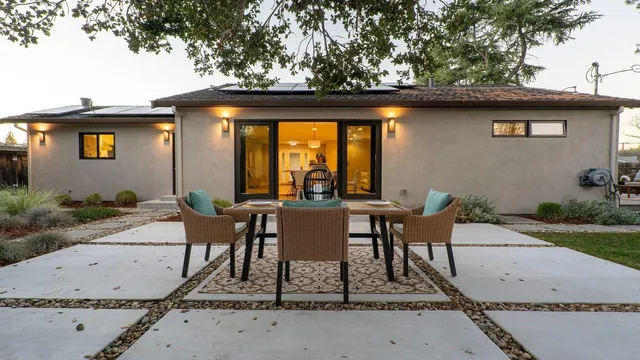 a living room with furniture and a painting on the wall