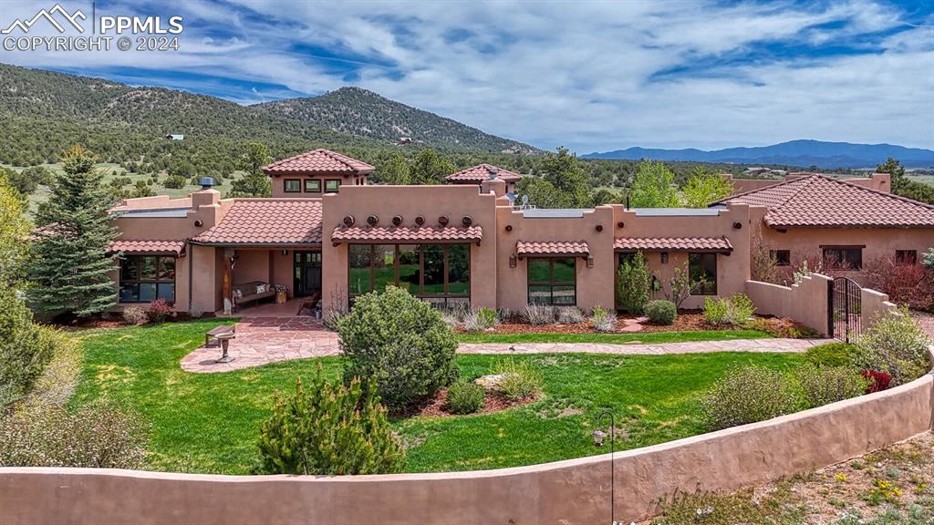 a front view of a house with a yard table and chairs