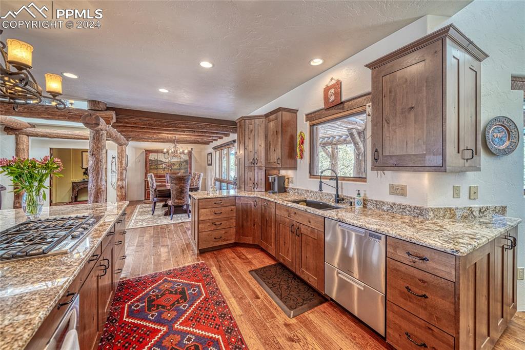 1328 Round Up Road Westcliffe, CO 81252 - Photo 15 of 50 a large kitchen with stainless steel appliances granite countertop a sink and wooden cabinets