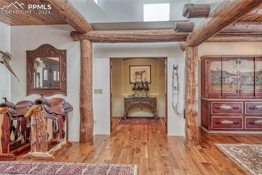 1328 Round Up Road Westcliffe, CO 81252 - Photo 22 of 50 a view of a hallway to a livingroom with wooden floor and furniture
