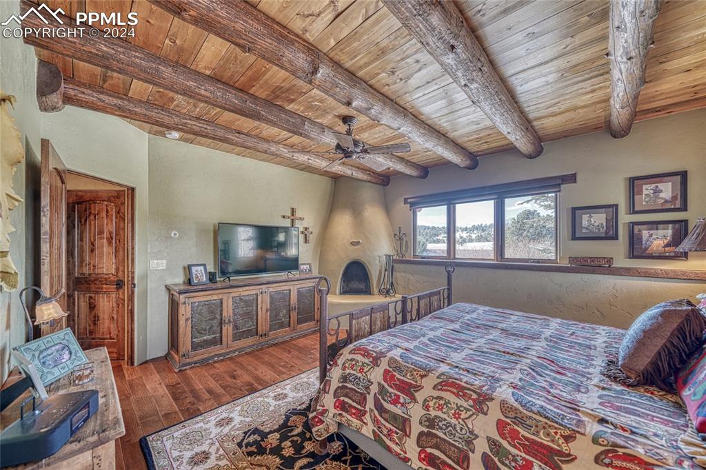 1328 Round Up Road Westcliffe, CO 81252 - Photo 24 of 50 a spacious bedroom with a bed and a flat screen tv