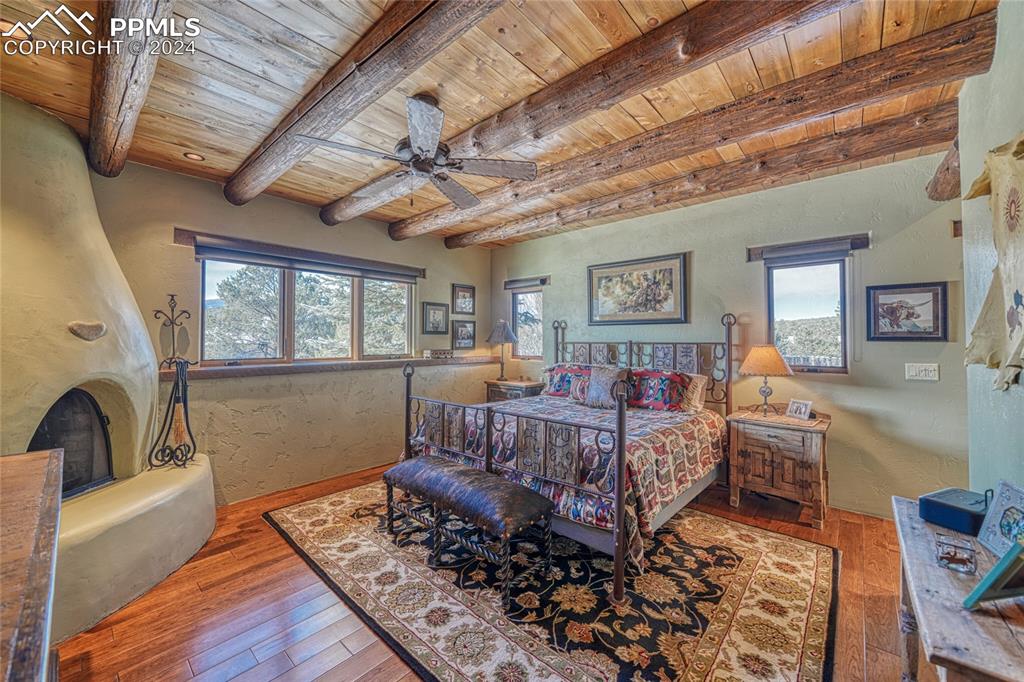 1328 Round Up Road Westcliffe, CO 81252 - Photo 26 of 50 a bed room with furniture and a fireplace