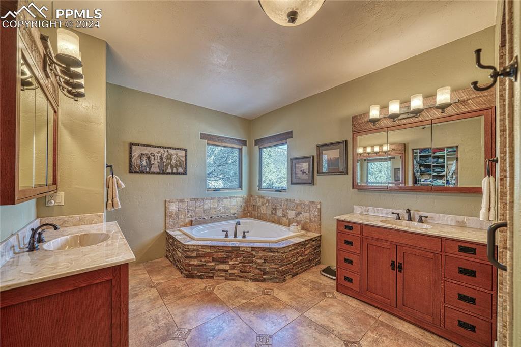 1328 Round Up Road Westcliffe, CO 81252 - Photo 27 of 50 a spacious bathroom with a granite countertop sink and a mirror