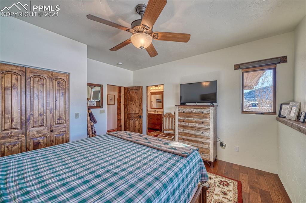 1328 Round Up Road Westcliffe, CO 81252 - Photo 31 of 50 a bedroom with a bed and a flat screen tv