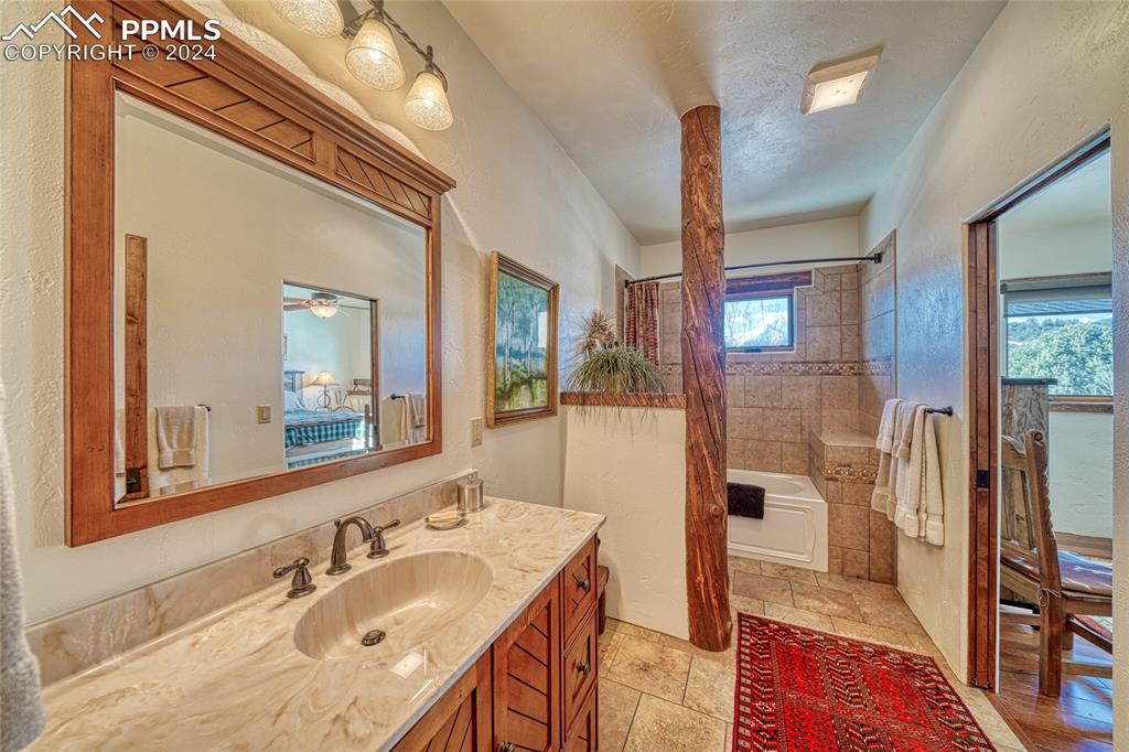 1328 Round Up Road Westcliffe, CO 81252 - Photo 32 of 50 a en suite bathroom with a granite countertop sink a mirror and shower