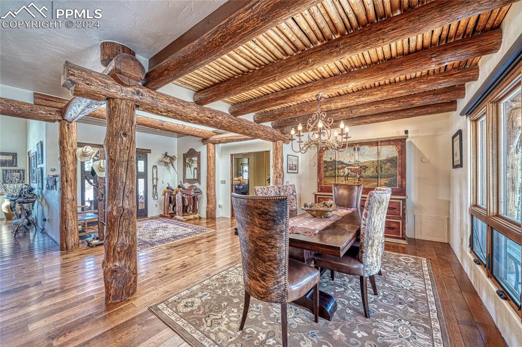1328 Round Up Road Westcliffe, CO 81252 - Photo 8 of 50 a view of a dining room with furniture wooden floor and chandelier