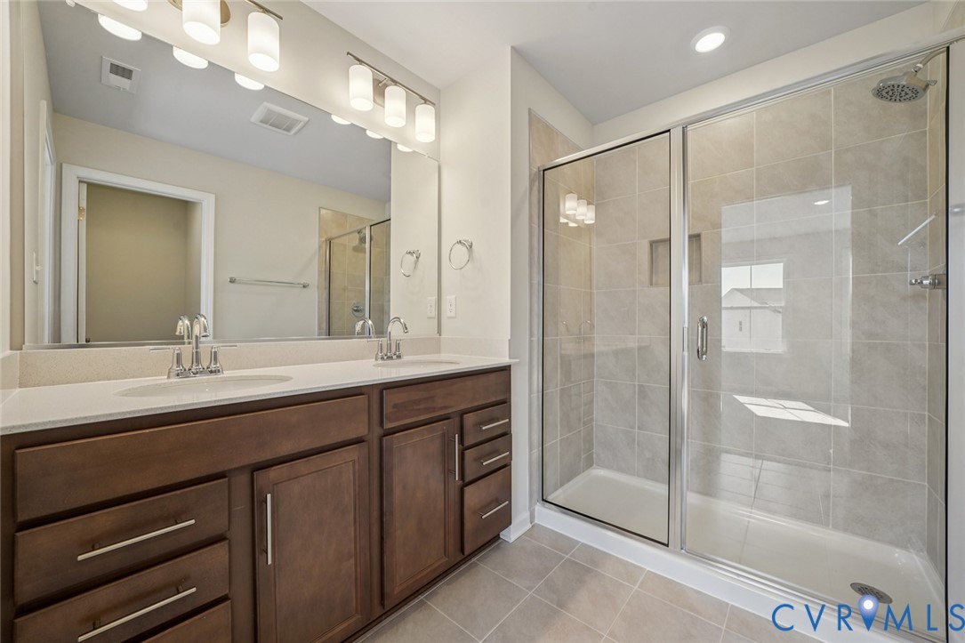 344 Mt Mccauley Way Aylett, VA 23009 - Photo 13 of 33 a bathroom with a double vanity sink mirror and shower