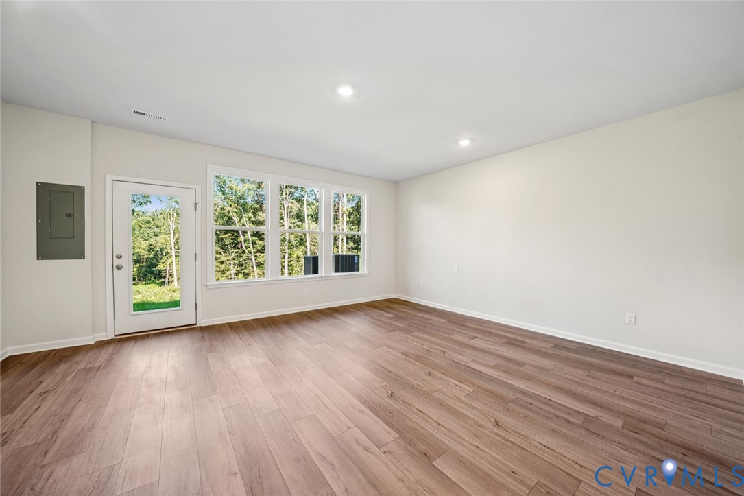 344 Mt Mccauley Way Aylett, VA 23009 - Photo 14 of 33 a view of an empty room with wooden floor and a window