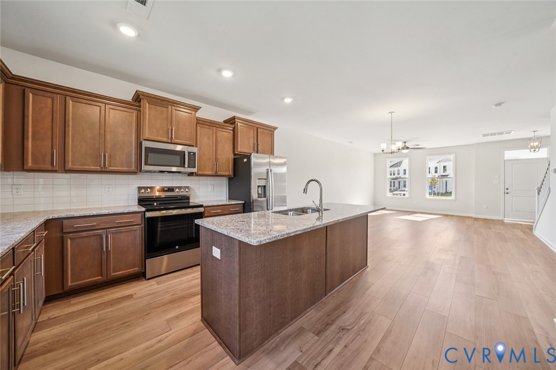 344 Mt Mccauley Way Aylett, VA 23009 - Photo 2 of 33 a kitchen with stainless steel appliances granite countertop a sink stove and oven