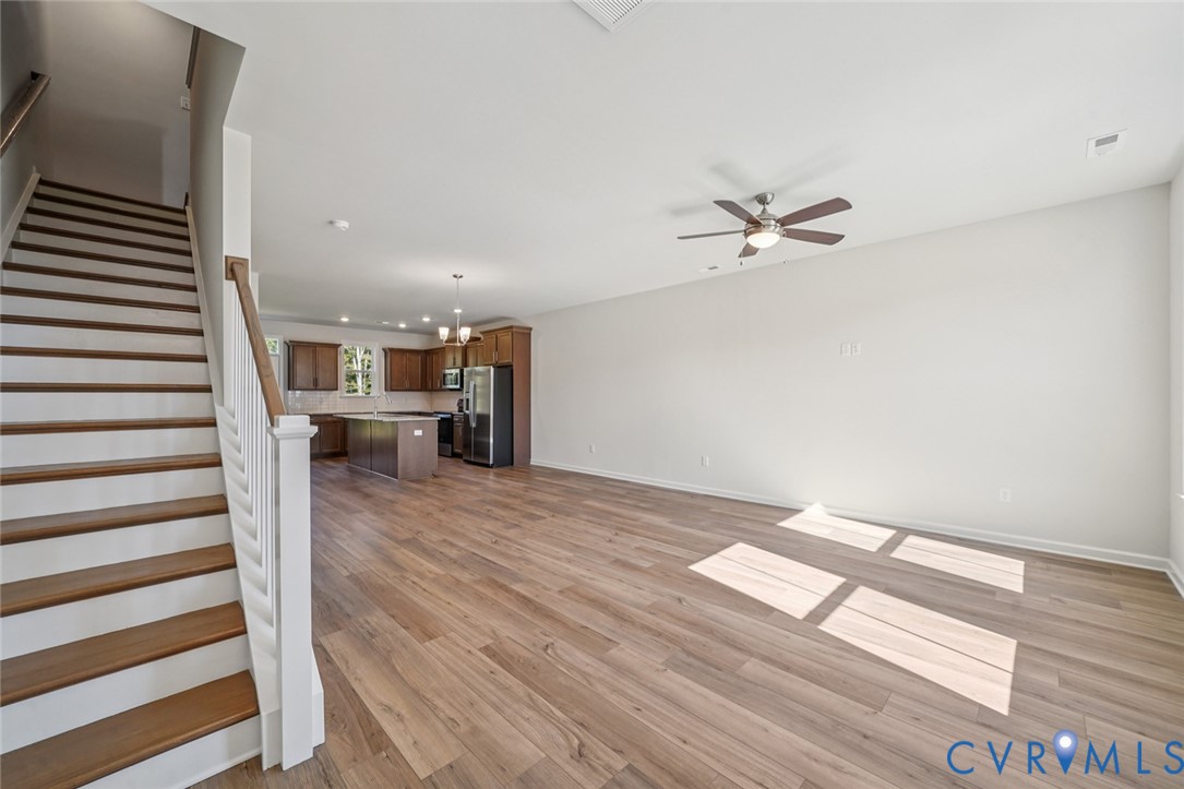 344 Mt Mccauley Way Aylett, VA 23009 - Photo 10 of 33 a view of a livingroom with a hardwood floor and a ceiling fan