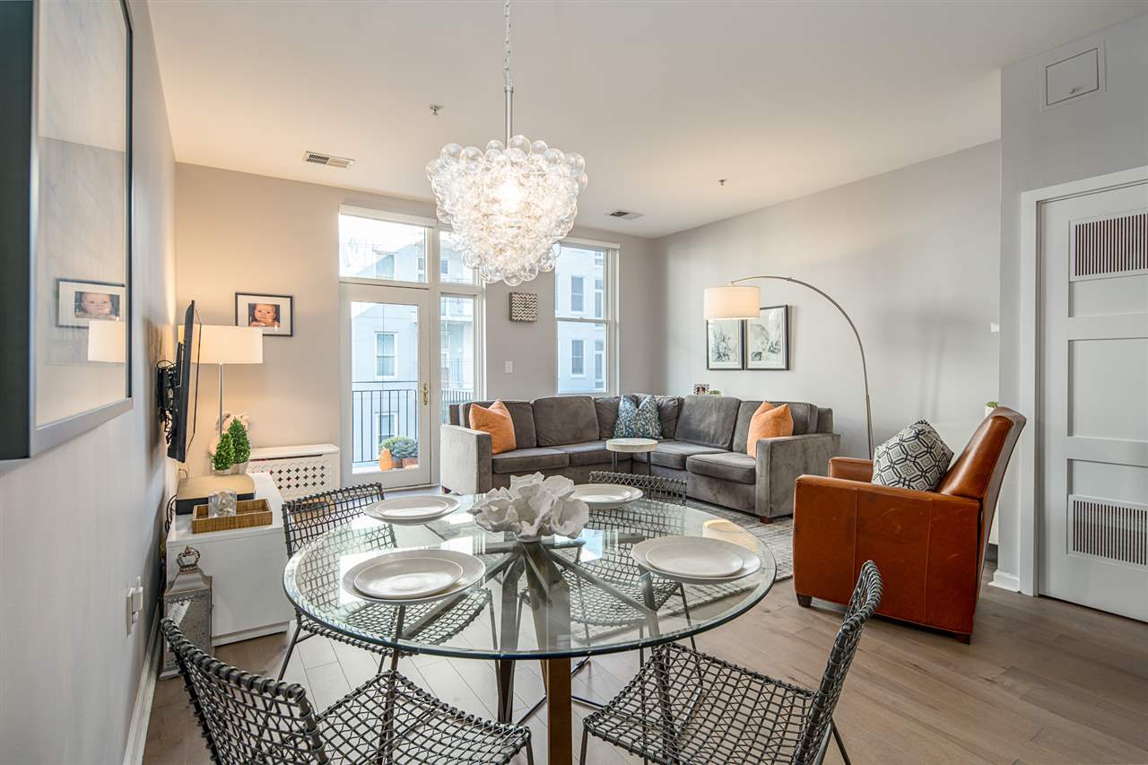 a living room with furniture chandelier and a table