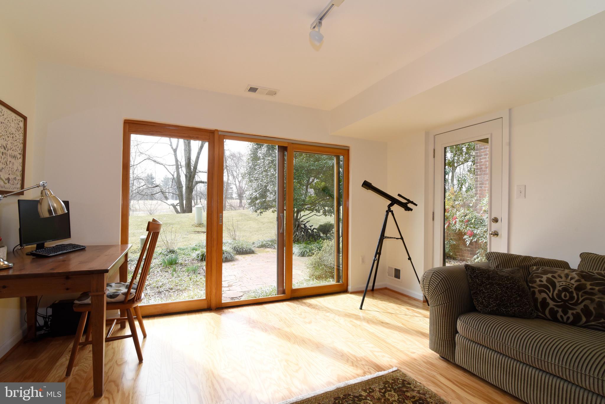 11749 Indian Ridge Road Reston, VA 20191 - Photo 37 of 53 a living room with furniture a flat screen tv and a large window