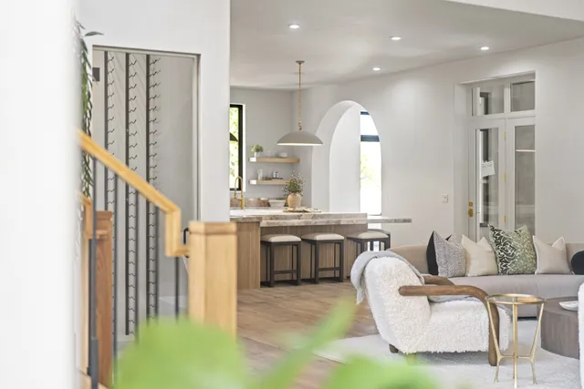 a living room with furniture a fireplace and a large window
