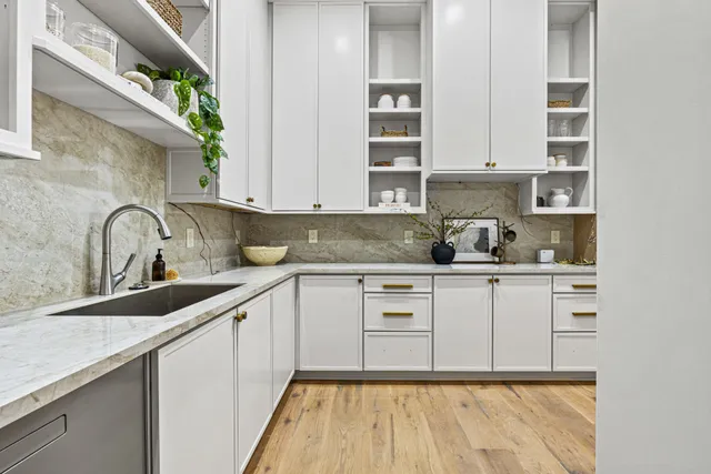 a kitchen with cabinets appliances and a sink