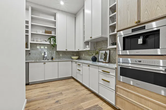 a kitchen with stainless steel appliances granite countertop a stove and cabinets