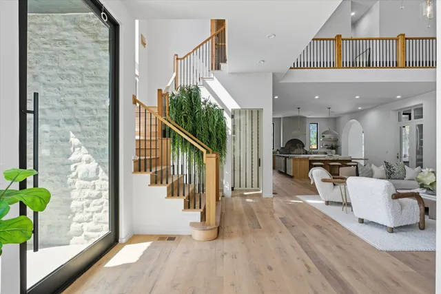 a view of entryway and hall with wooden floor