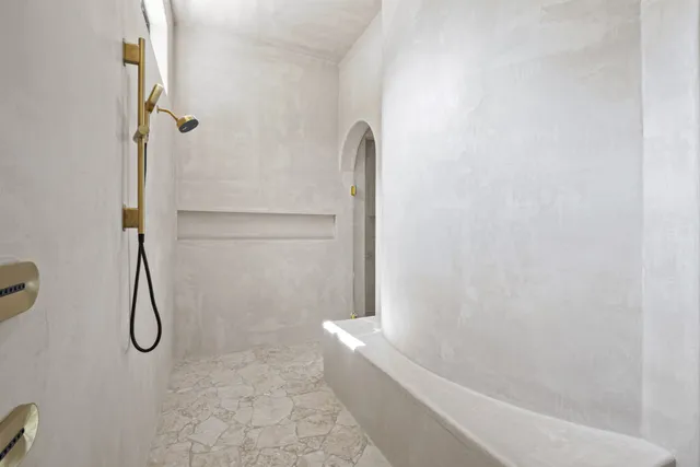 a bathroom with a bath tub with a shower