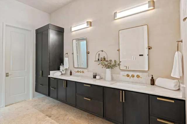 a bathroom with a double vanity sink and mirror
