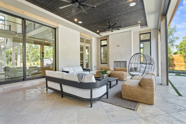 a living room with furniture and large windows