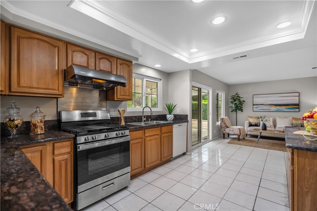 697 Farben Drive Diamond Bar, CA 91765 - Photo 23 of 54 a kitchen with stainless steel appliances granite countertop a stove a sink and a microwave