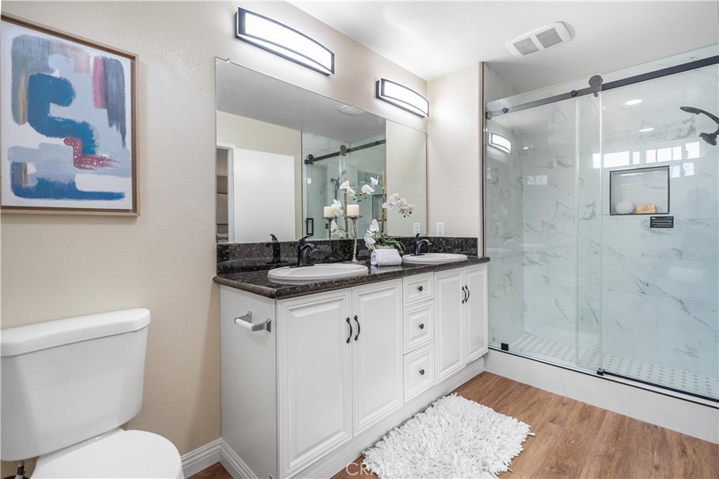 697 Farben Drive Diamond Bar, CA 91765 - Photo 40 of 54 a bathroom with a granite countertop sink mirror toilet and shower