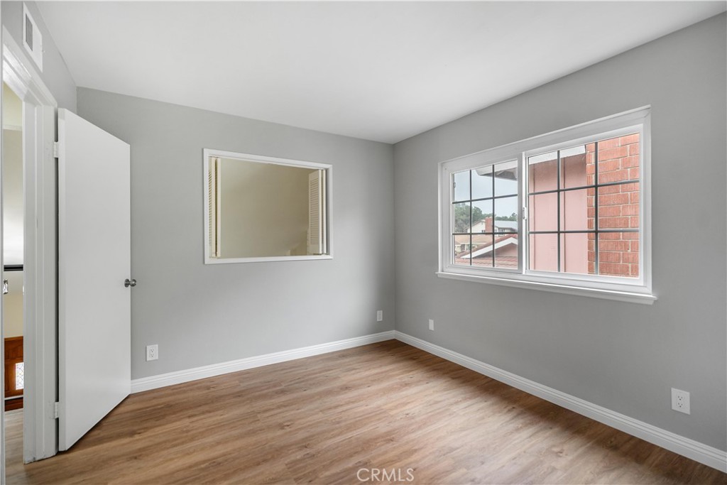 697 Farben Drive Diamond Bar, CA 91765 - Photo 42 of 54 an empty room with wooden floor and windows