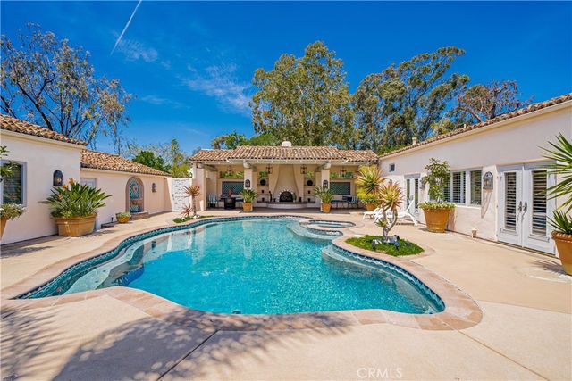a view of a swimming pool with chairs