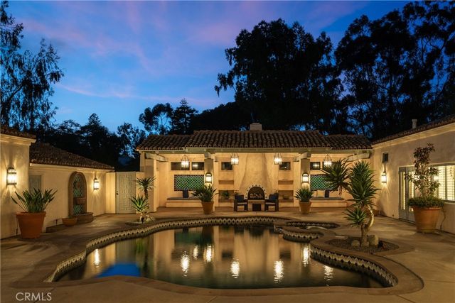 a view of a swimming pool with outdoor seating